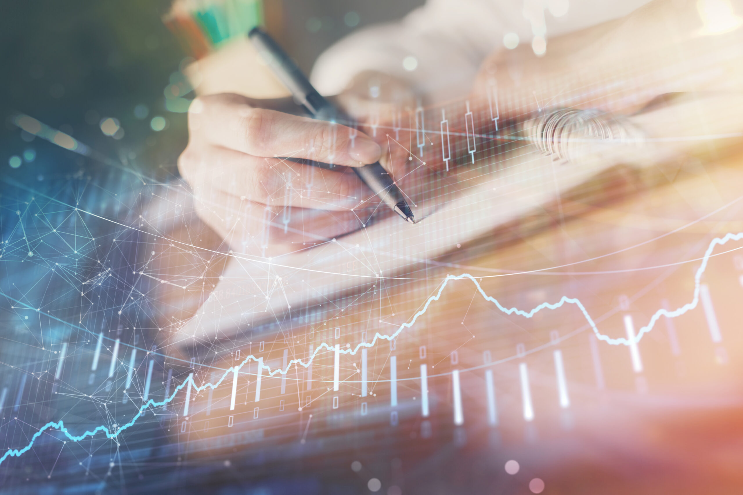 Financial forex graph displayed on hands taking notes background