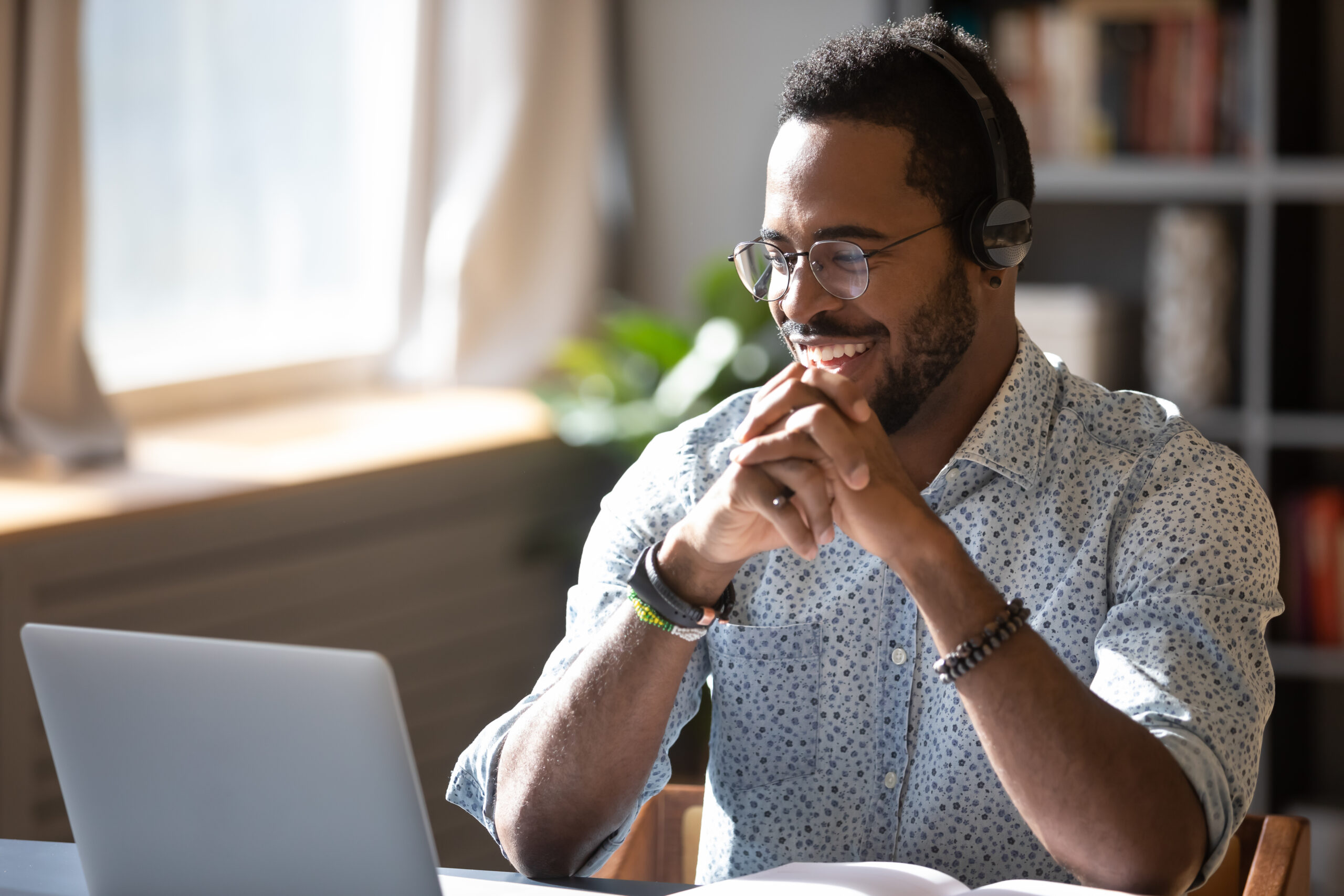 man in glasses looking at his laptop